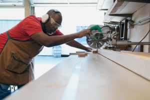 Carpenter using a table saw to cut wood