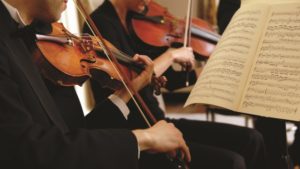 Violinists performing at a concert